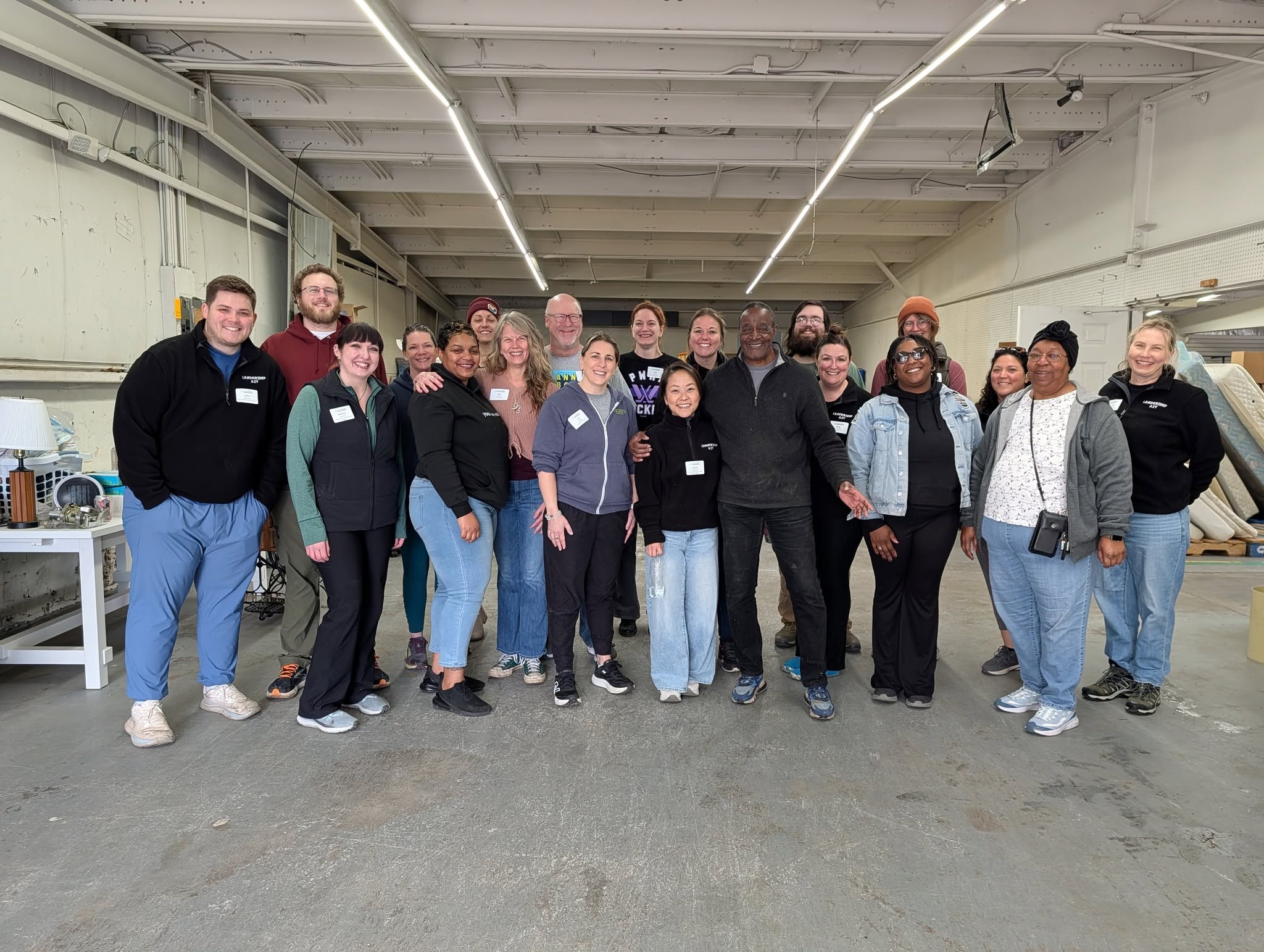 Volunteers gathered at the Friends in Deed furniture warehouse